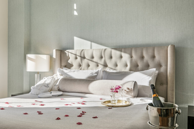 Bed with Rose petals and champagne